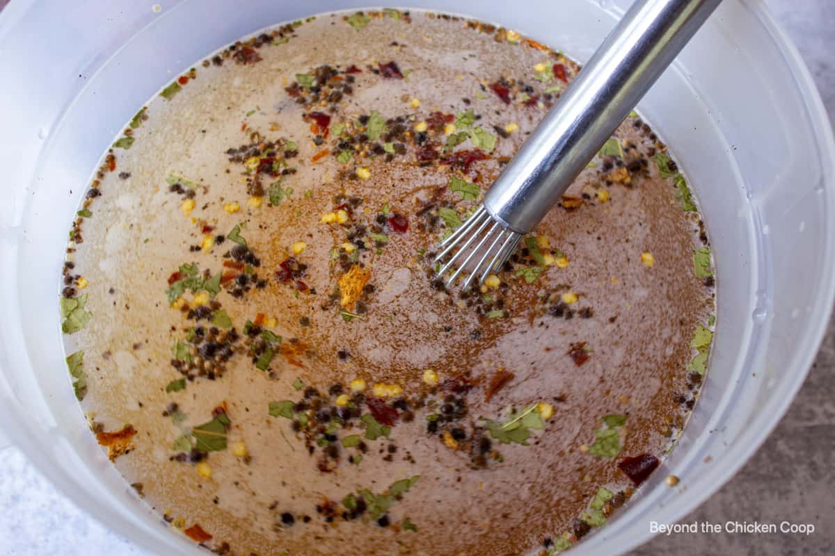 Looking down into a bucket filled with water and spices.