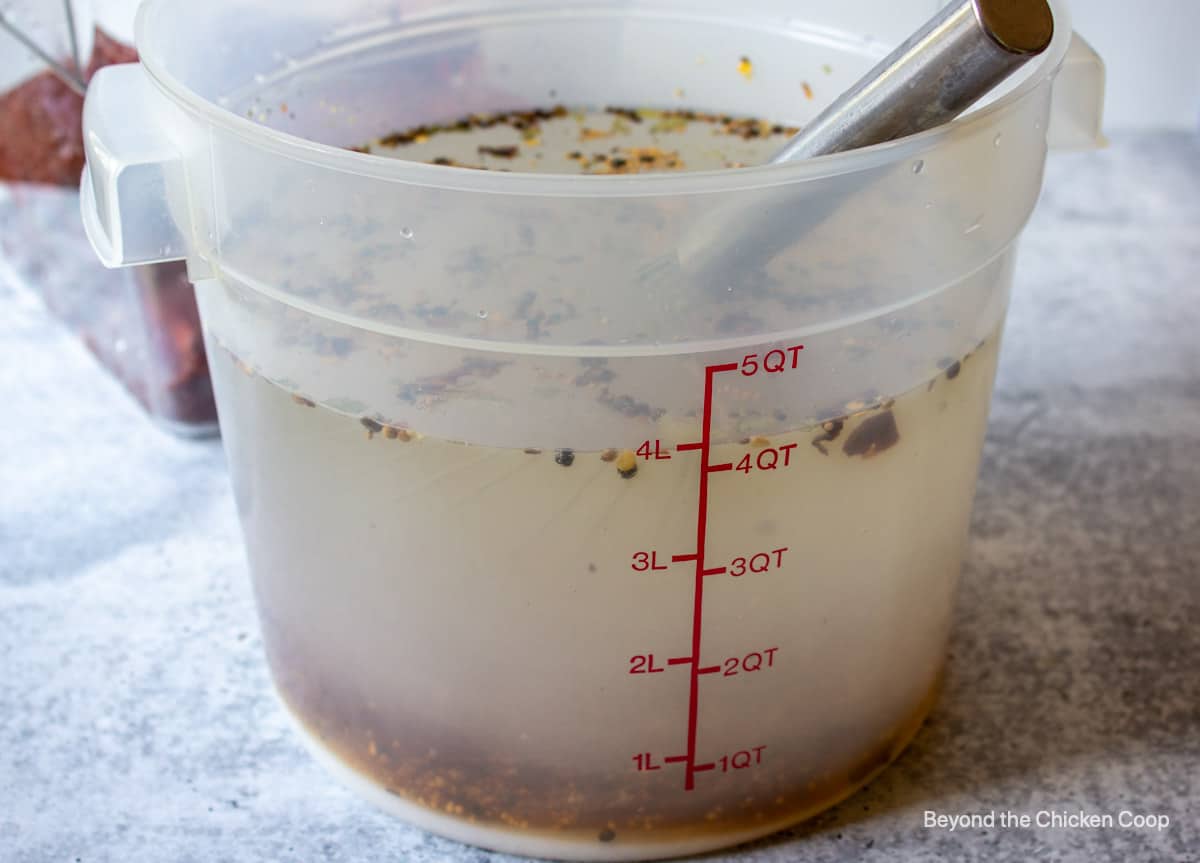 A large plastic tub filled with water and seasonings.