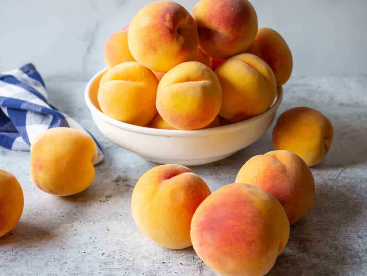 Fresh peaches on a counter.