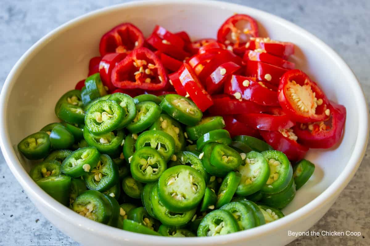 Sliced red and green jalapeno peppers.