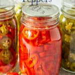 Canning jars filled with red and green chile peppers.