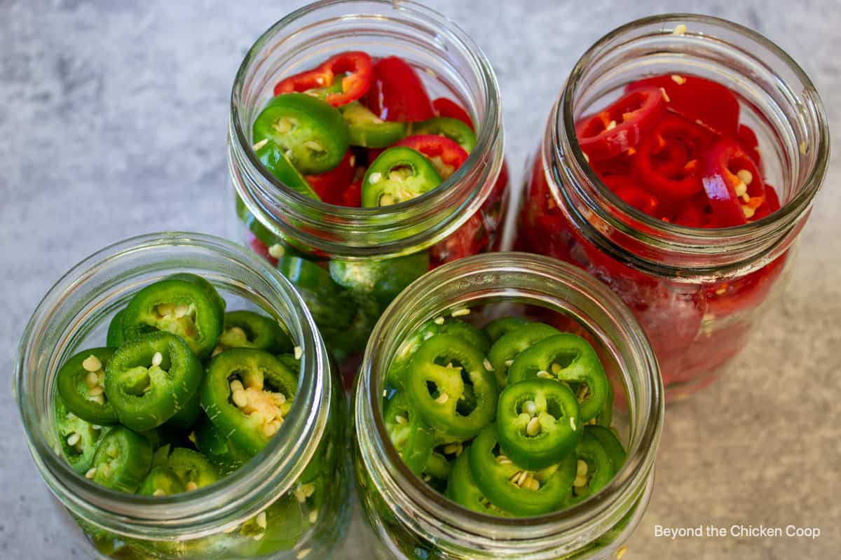 Slice peppers in canning jars.