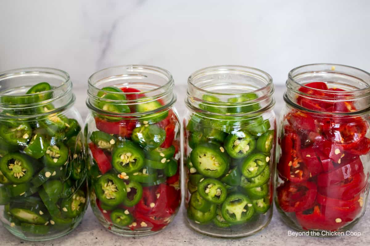 Jars filled with sliced jalapenos.