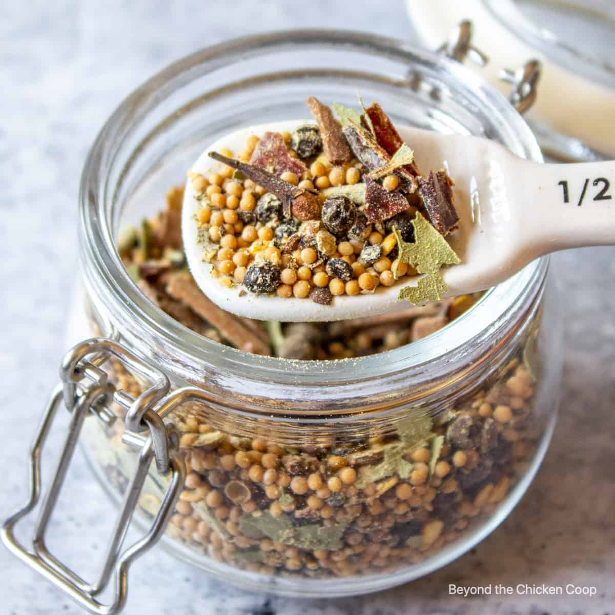 Spices in a jar with a teaspoon.
