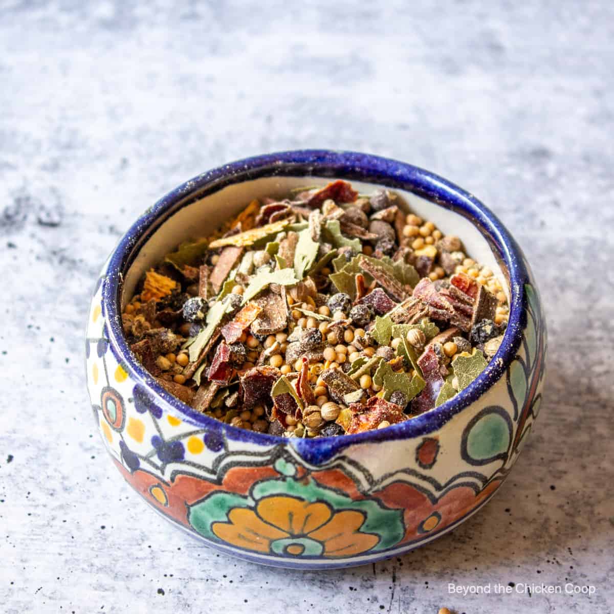 A colorful dish filled with pickling spice.