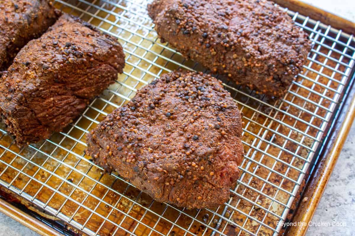 Small roasts on a baking rack.