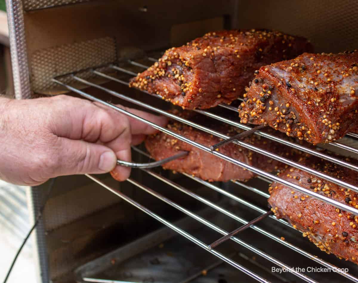 Inserting a digital thermometer in a venison roast.