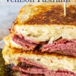 A reuben sandwich with pastrami, cheese and sauerkraut.