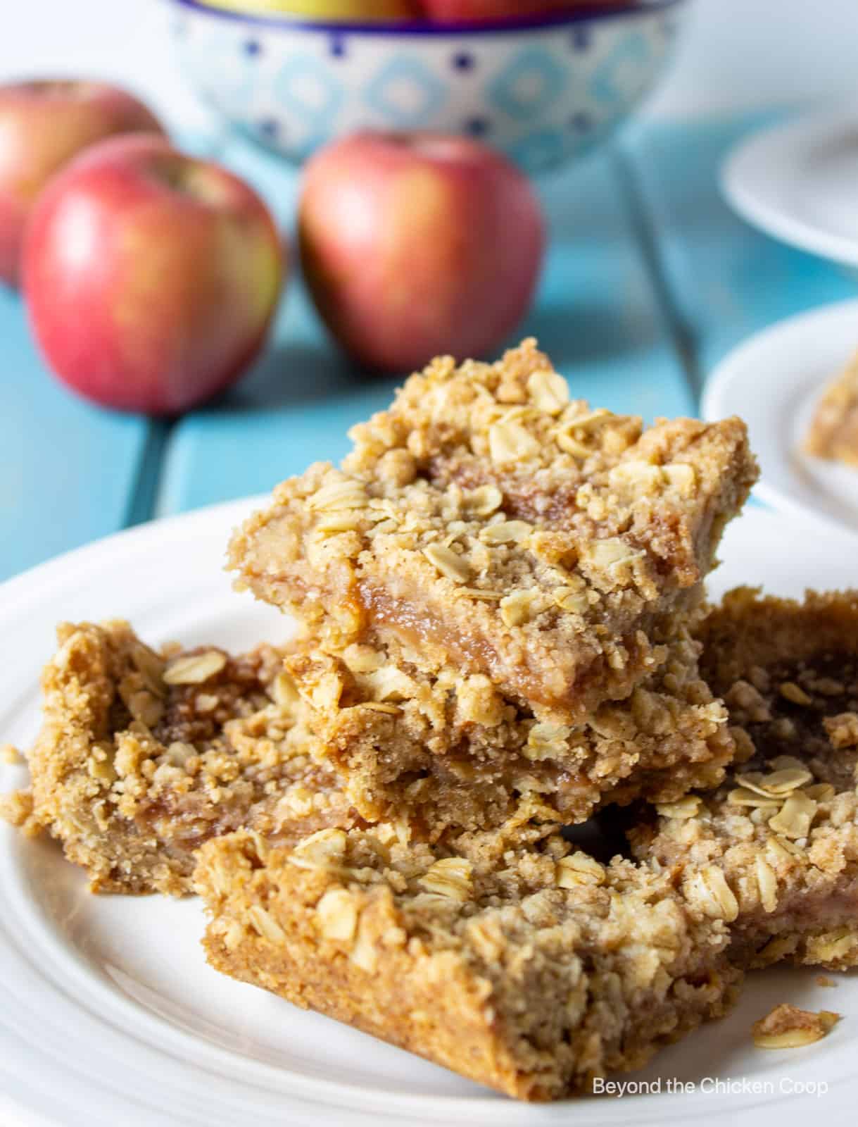 Oat bars stacked on a white plate.