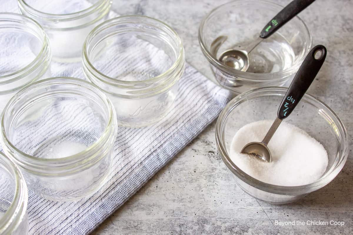 A measuring spoon in a bowl with salt.