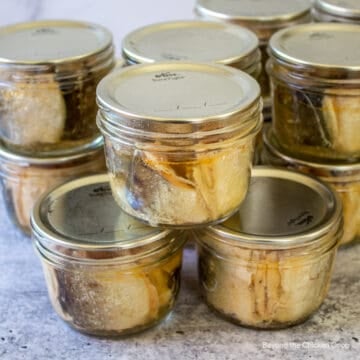 Small canning jars filled with chunks of fish.