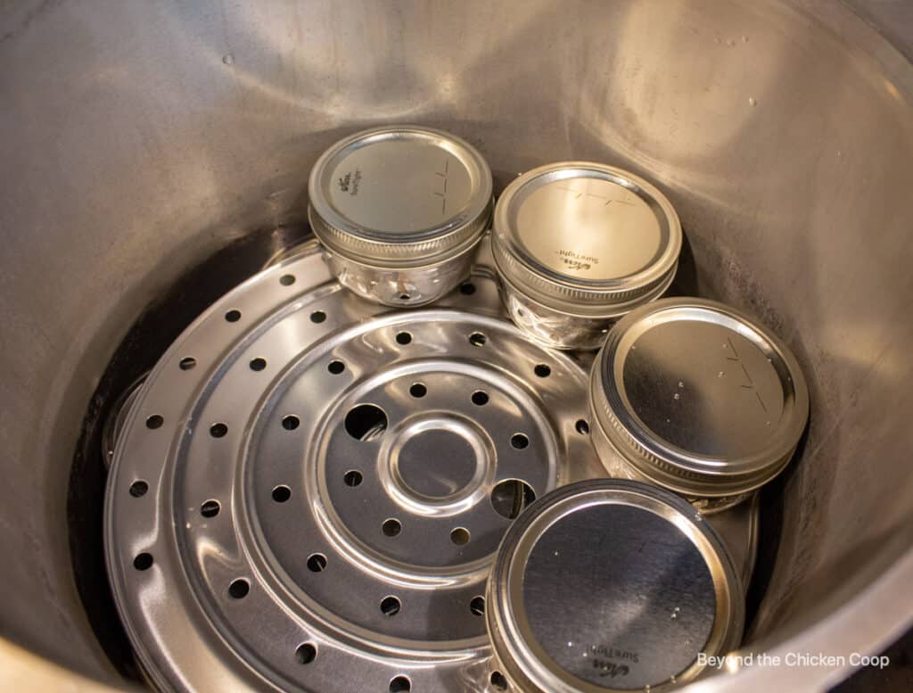 Placing jars in a pressure cooker.