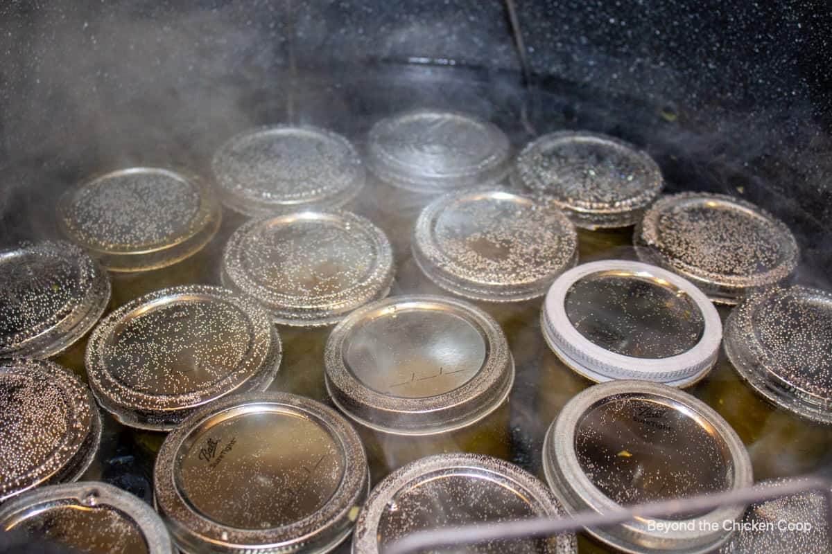 A hot water bath canner filled with jars.