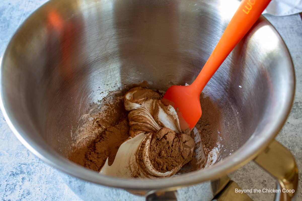 Folding cocoa powder into meringue.
