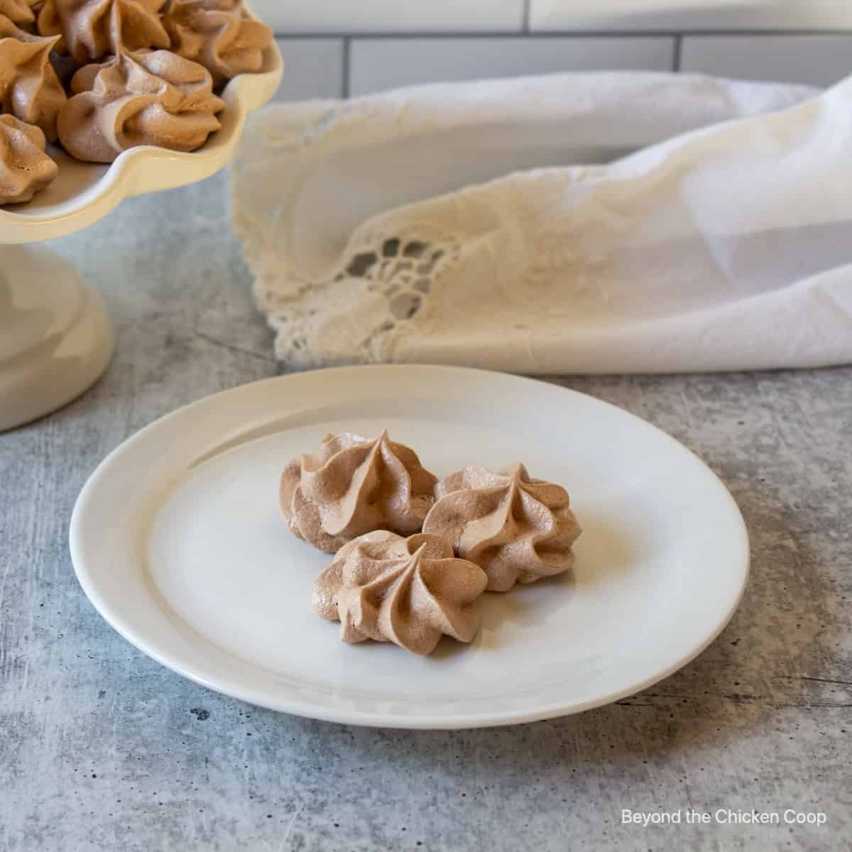 Three small meringue cookies on a plate.