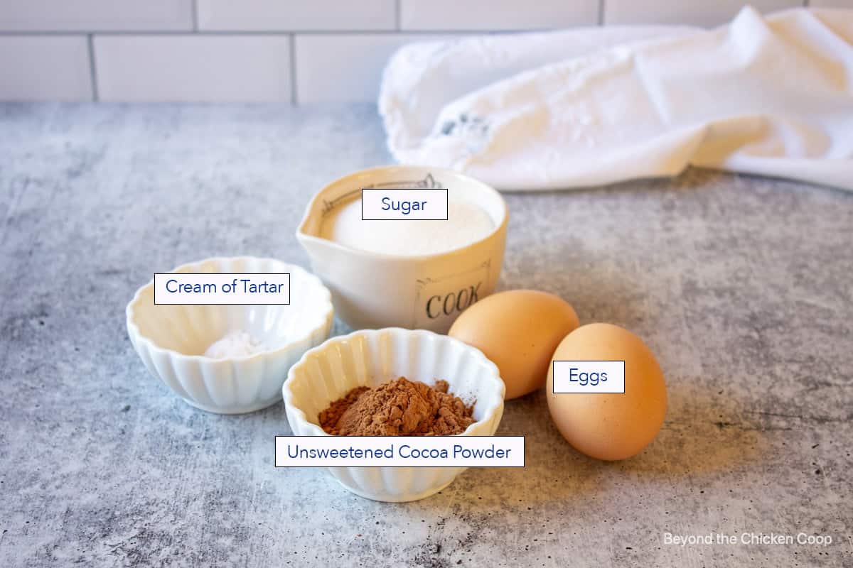 Ingredients for making meringue cookies with cocoa powder.