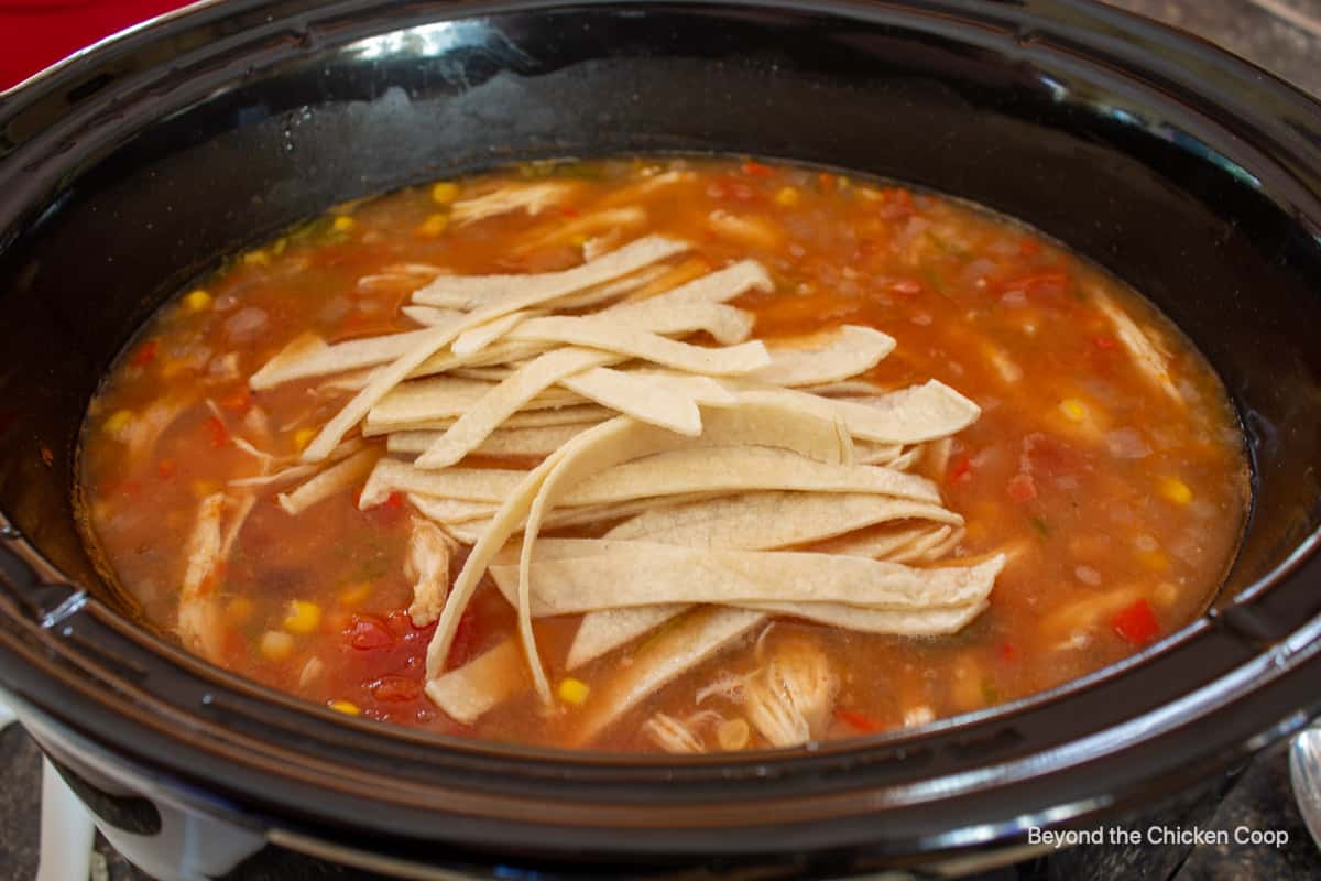A crockpot filled with chicken tortilla soup.
