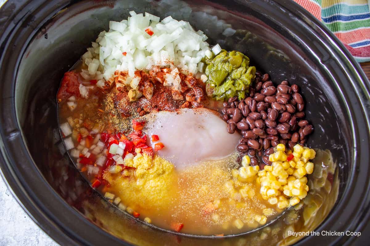 A crockpot filled with soup ingredients.
