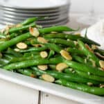 Green beans with almonds on a platter.
