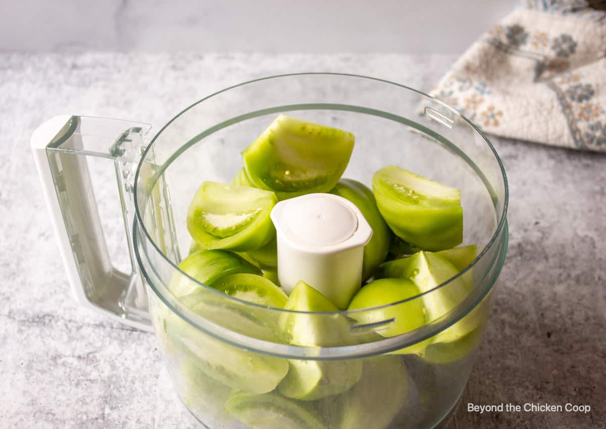 A bowl with quartered green tomatoes.