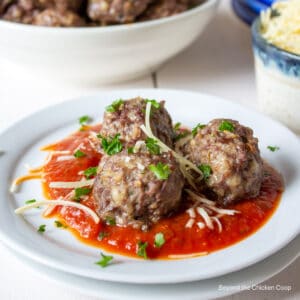 Three meatballs on a plate.