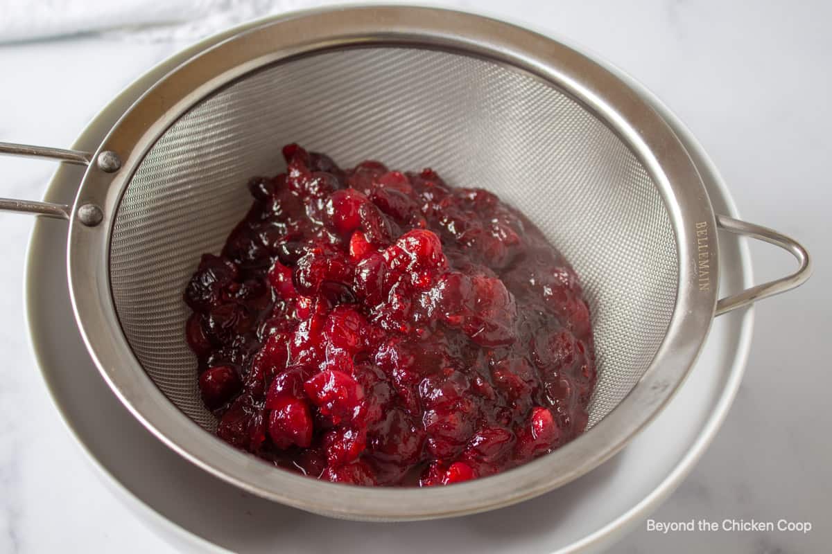 Cranberries in a fine sieve.