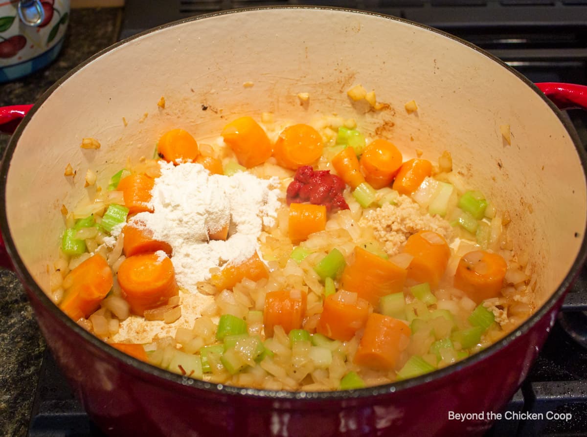 A pot with carrots, onions and celery.