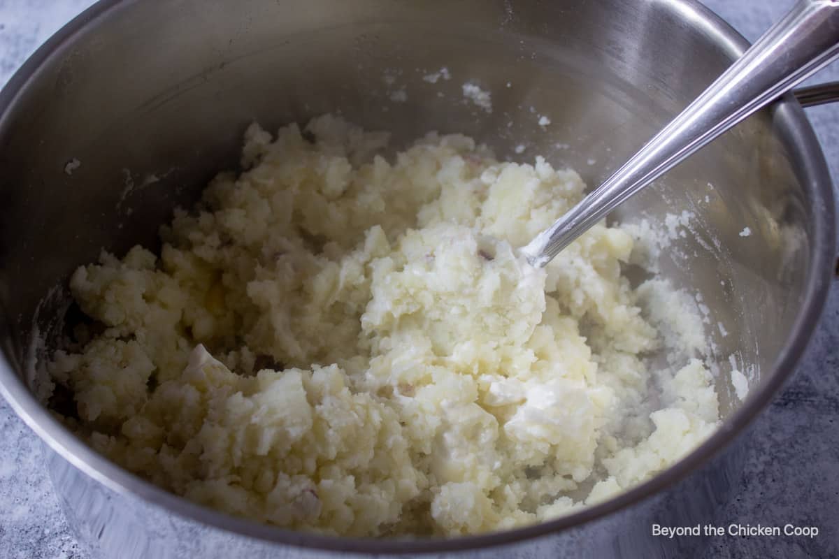 Potatoes in a pot with a spoon.