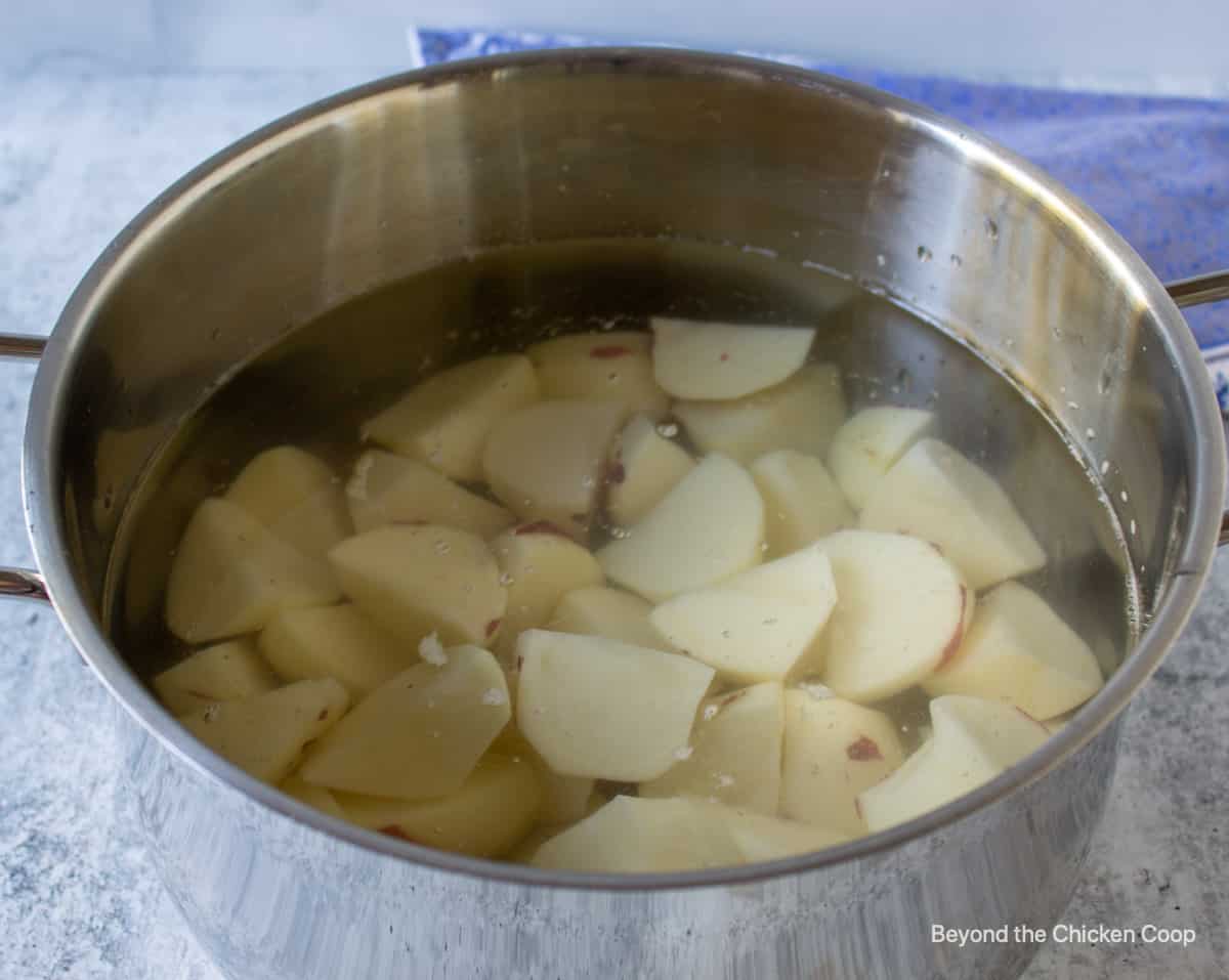 Potatoes in a pot filled with water.