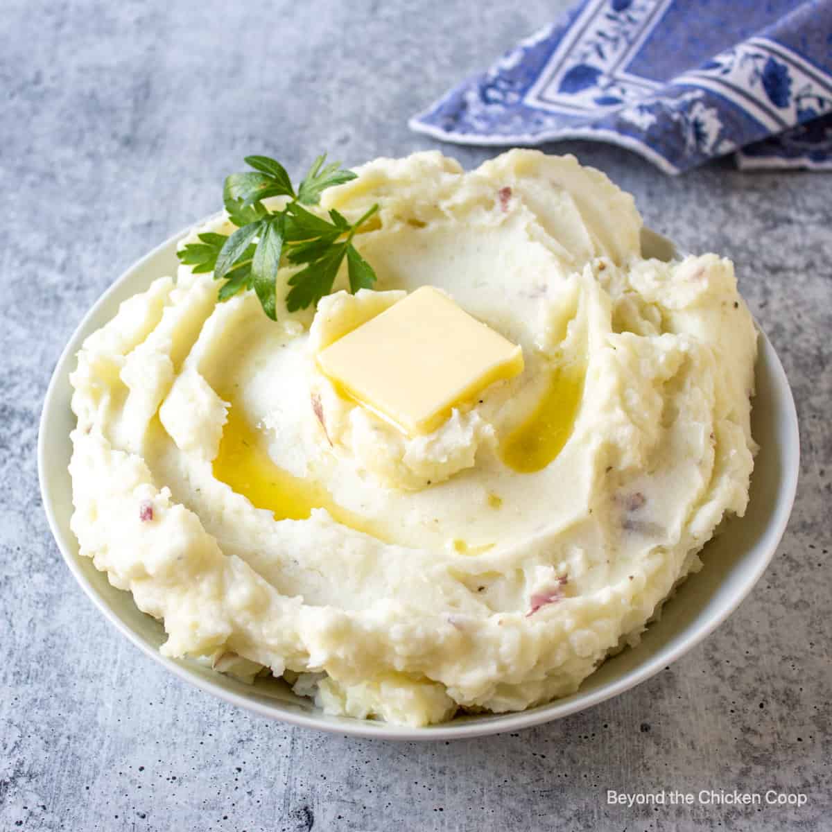 Mashed red potatoes topped with a pat of butter.