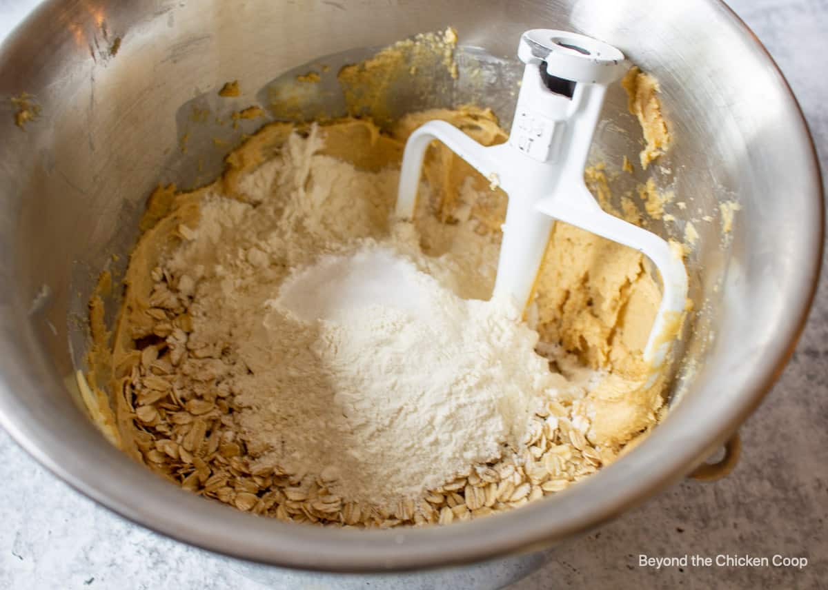 Flour and oats added to cookie dough.