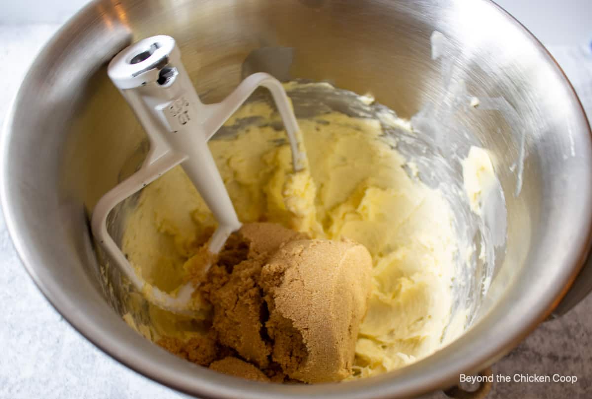 Brown sugar and butter in a mixing bowl.