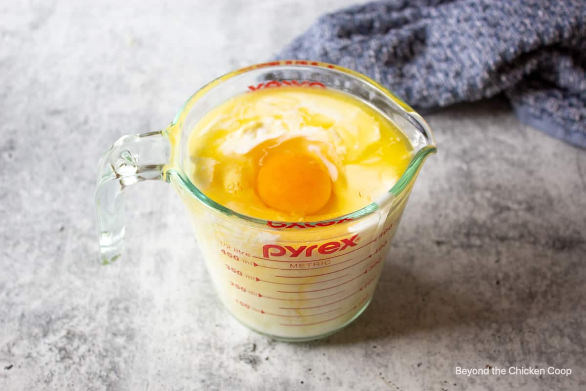 And and milk in a large measuring cup.