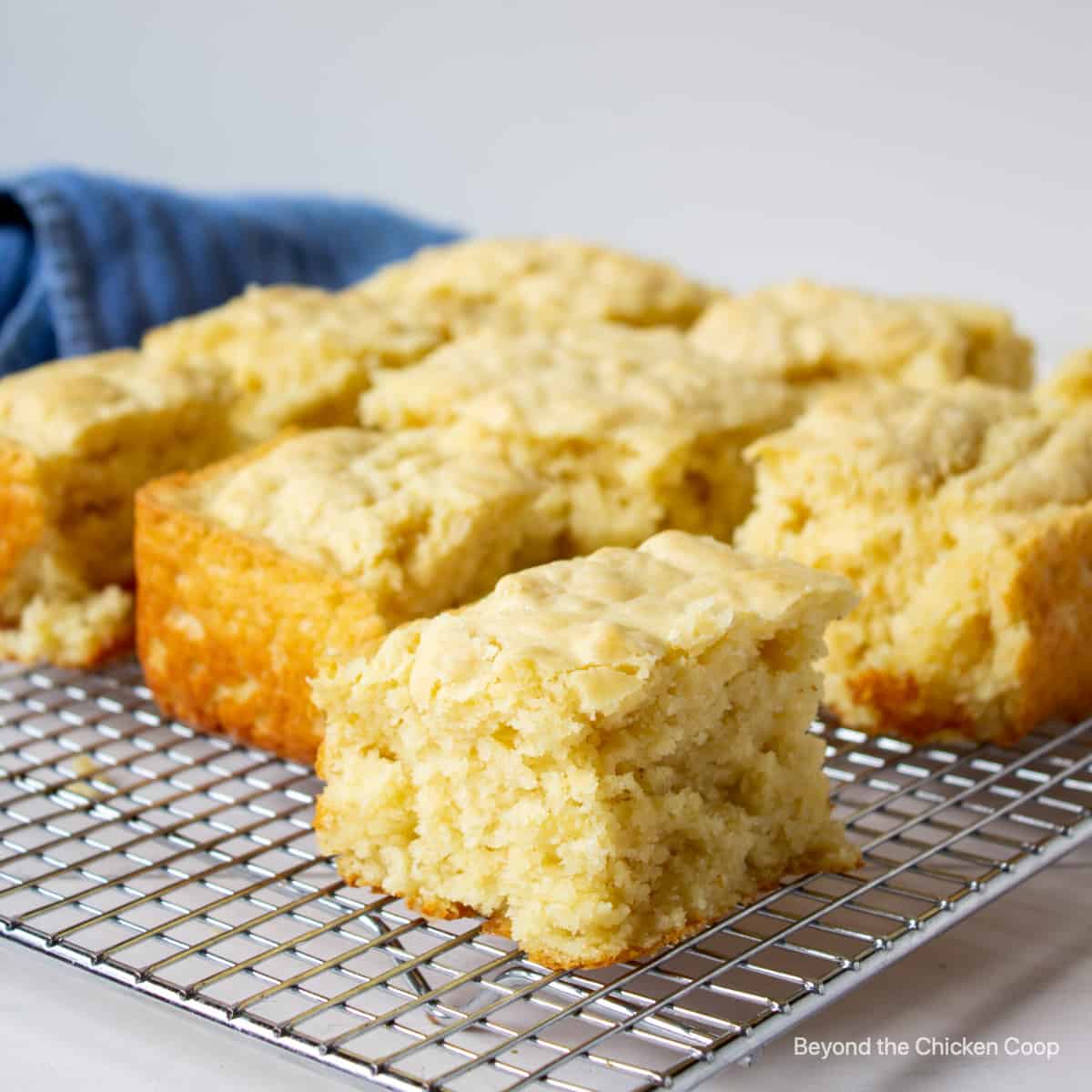 Square cut biscuits on a cooling rack.