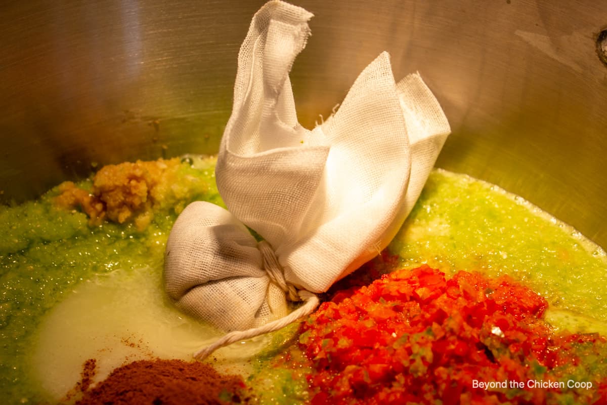 A spice packet in a large pot with pureed veggies.