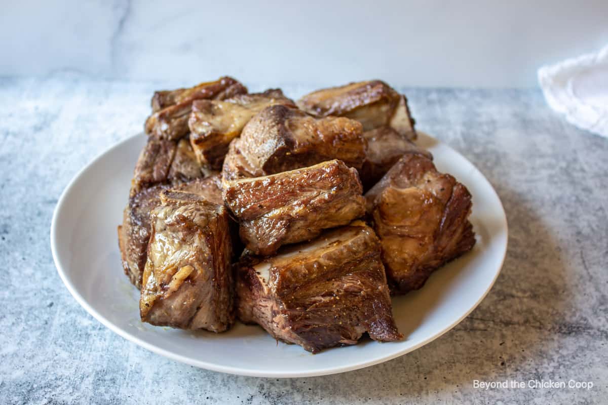 Browned ribs on a plate.