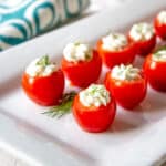 A platter filled with cheese stuffed tomatoes.