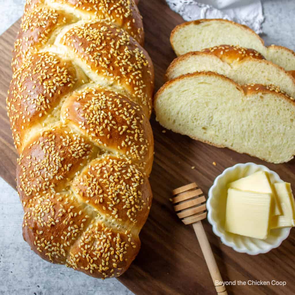 A loaf of braided bread topped with sesame seeds.