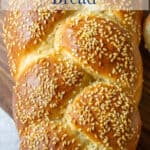 A braided loaf of bread topped with sesame seeds.