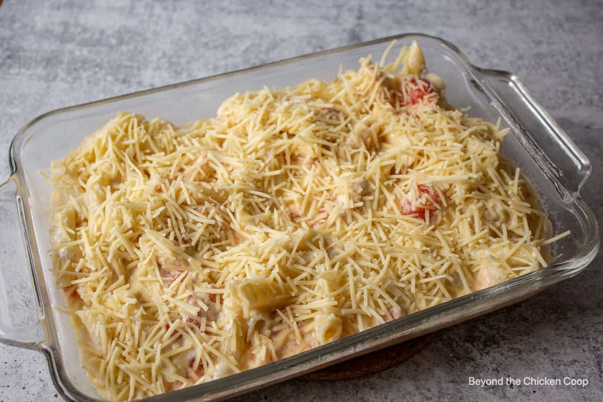 A casserole dish filled with pasta and topped with cheese.