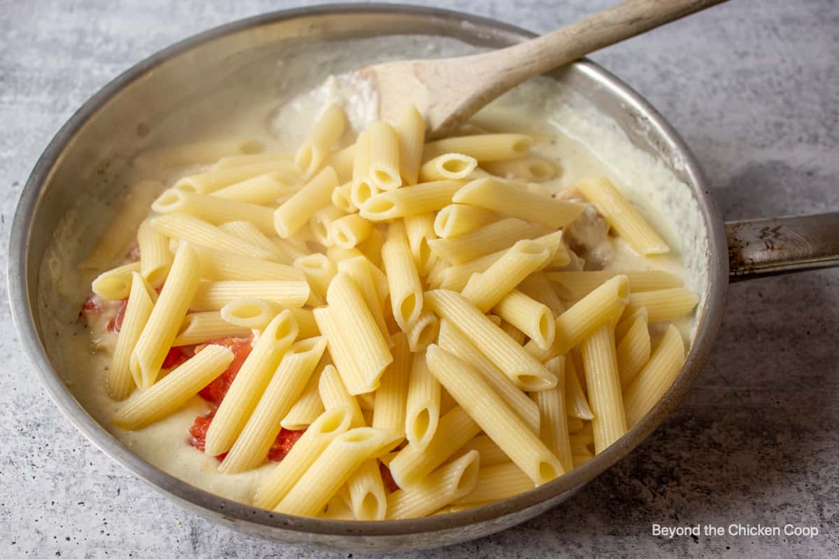 Penne pasta in a saute pan.