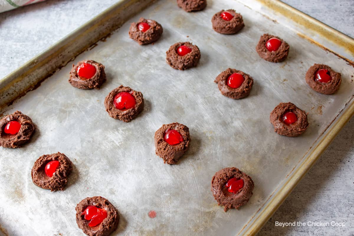 Maraschino cherries in the center of chocolate cookie dough.