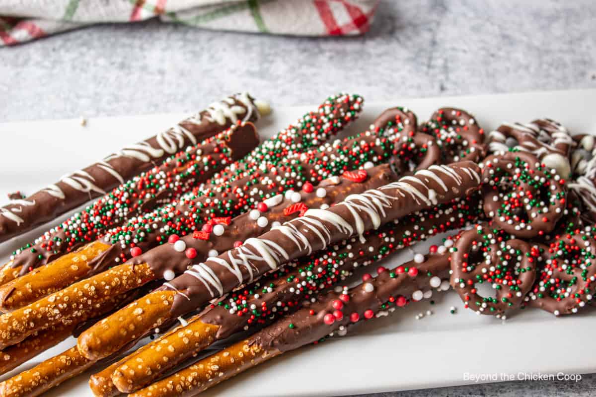 Pretzels covered with chocolate and sprinkles.