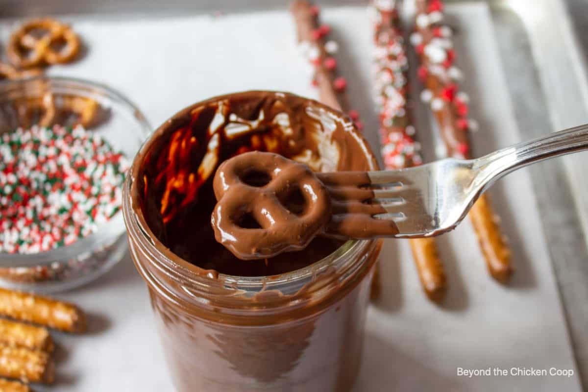 A pretzel with chocolate on a fork.