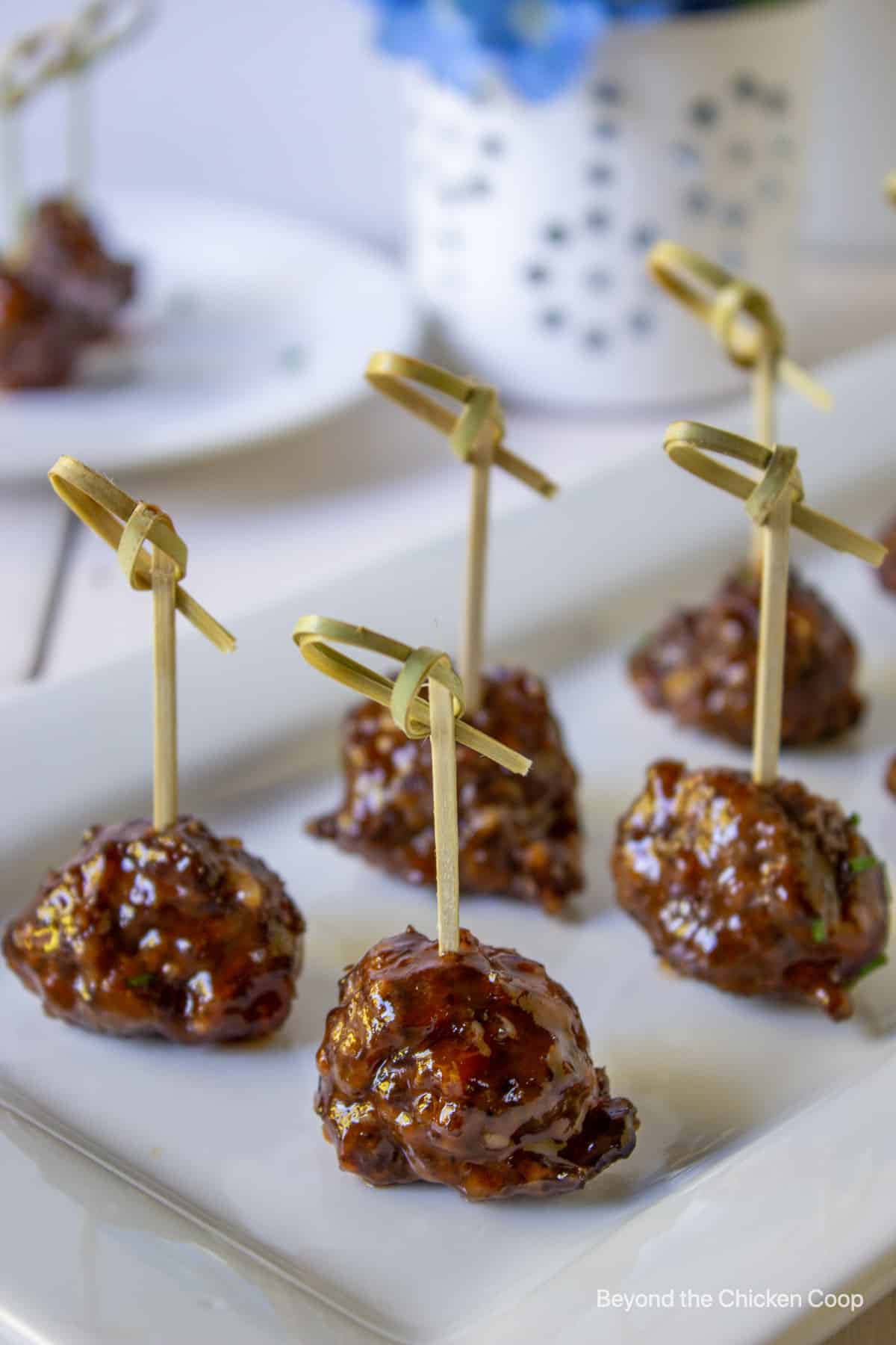 Cocktail meatballs with a fancy toothpick.