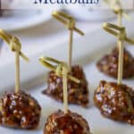 Meatballs with fancy toothpicks on a platter.