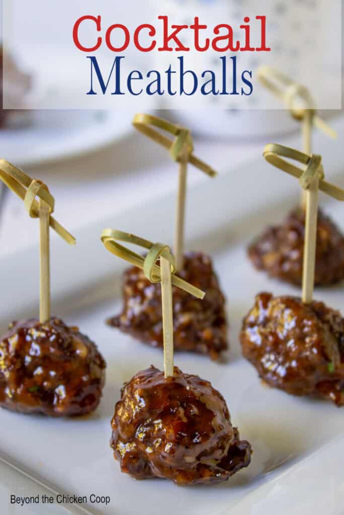 Meatballs with fancy toothpicks on a platter.