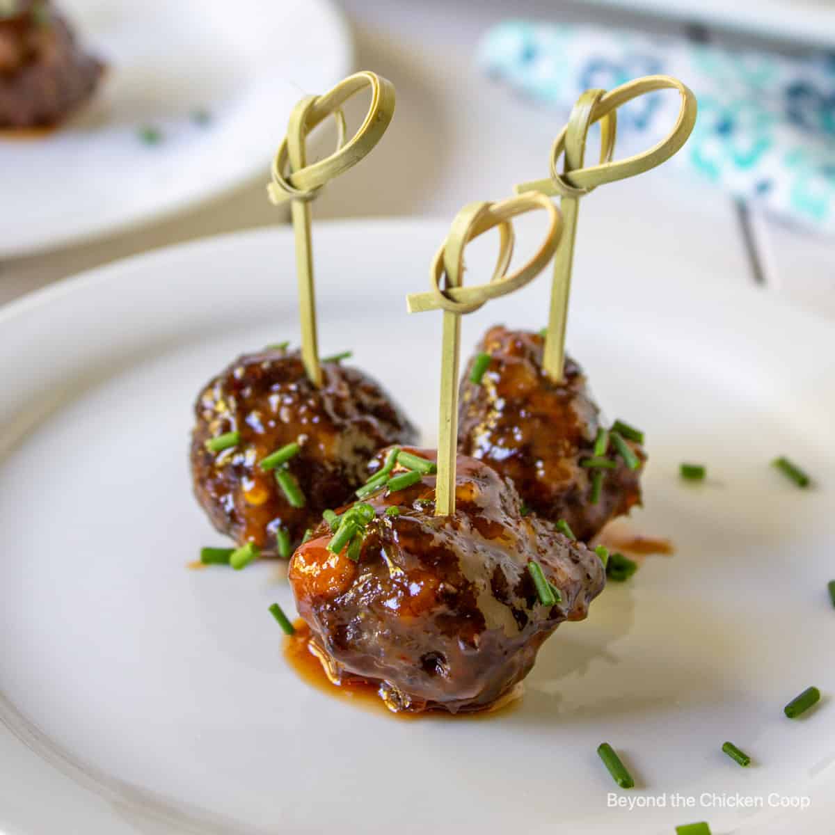 Three small meatballs on a plate.