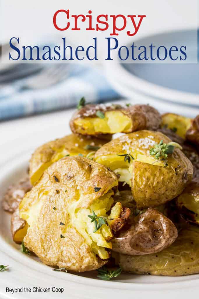 A plate filled with flattened smashed potatoes.