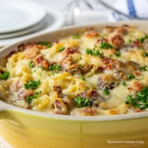 A casserole dish filled with a pasta and ham casserole.